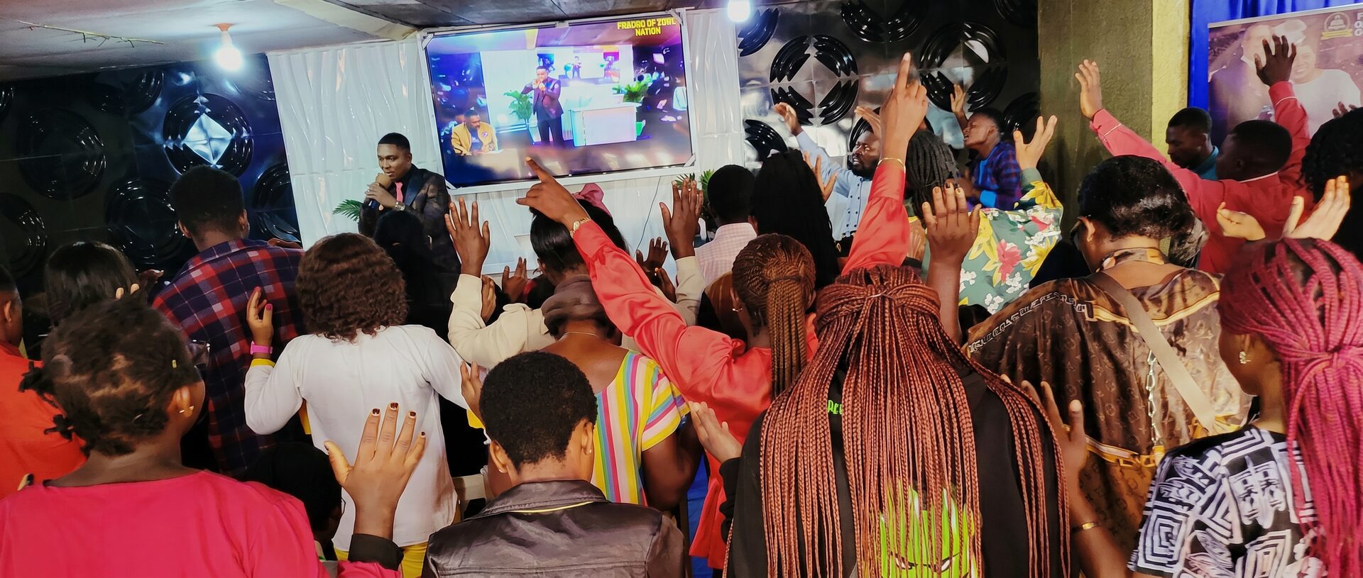 FOHN congregation in passionate worship with hands raised